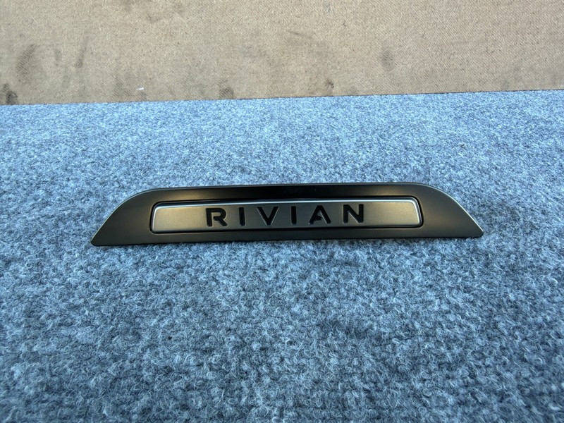 RIVIAN R1S 2022-2026 OEM REAR 3RD ROW SEAT COVER BADGE LOGO PLATE ASSEMBLY