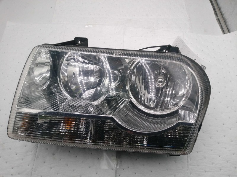 Used Left Headlight Assembly fits: 2010 Chrysler 300 halogen w/o projector Left