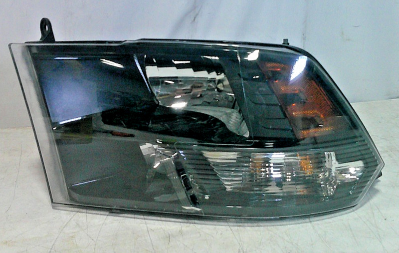 2009-2018 Dodge Ram 1500 Front Left Driver Side Dark Bezel Headlight. OEM