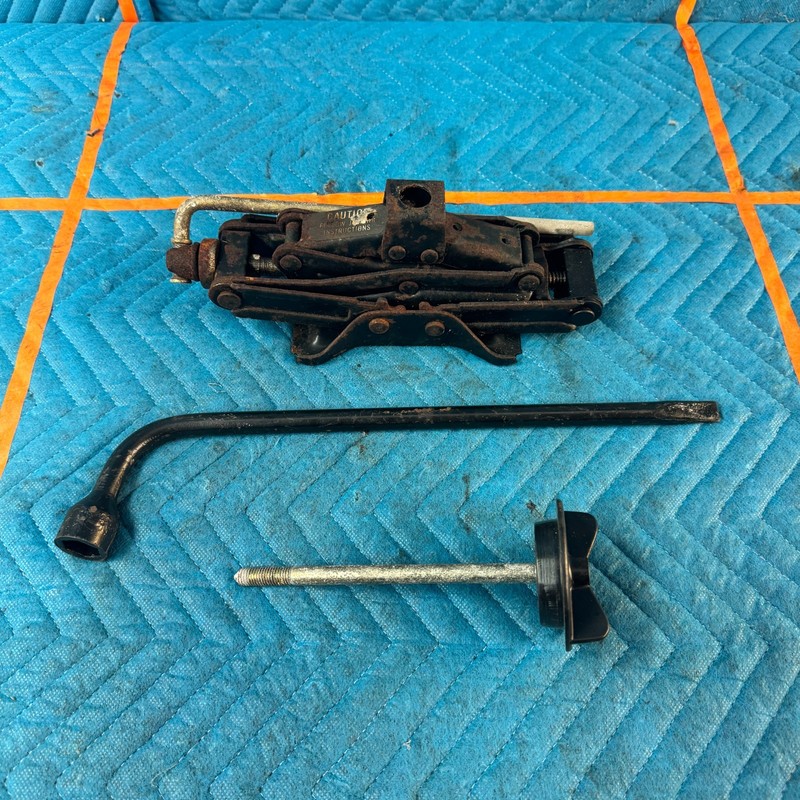 1989-1991 Chrysler TC Maserati Scissor Jack Lug Wrench Hold Down OEM 46K