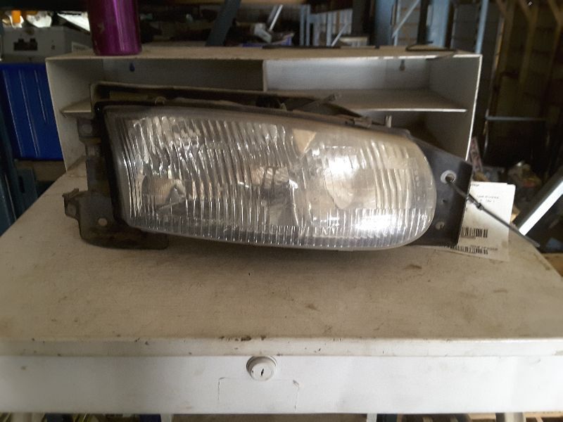 95 96 RIVIERA R. HEADLIGHT W/BLACK TRIM ON LENS 65205