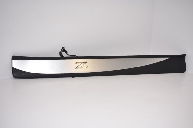 NISSAN 370Z ROADSTER G6952-1EA0A, RH KICK PLATE TRIM PANEL, BLK, SILVER